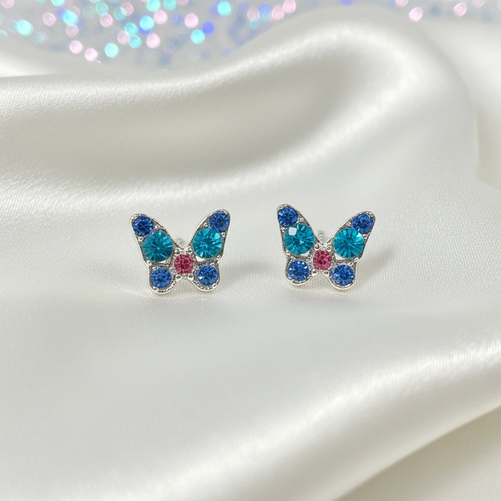 Mini Blue Crystal Butterfly Earrings with colorful gemstones on a round white card.