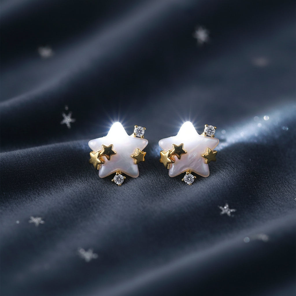 Pearlescent Star & Crystal Earrings on a charcoal background