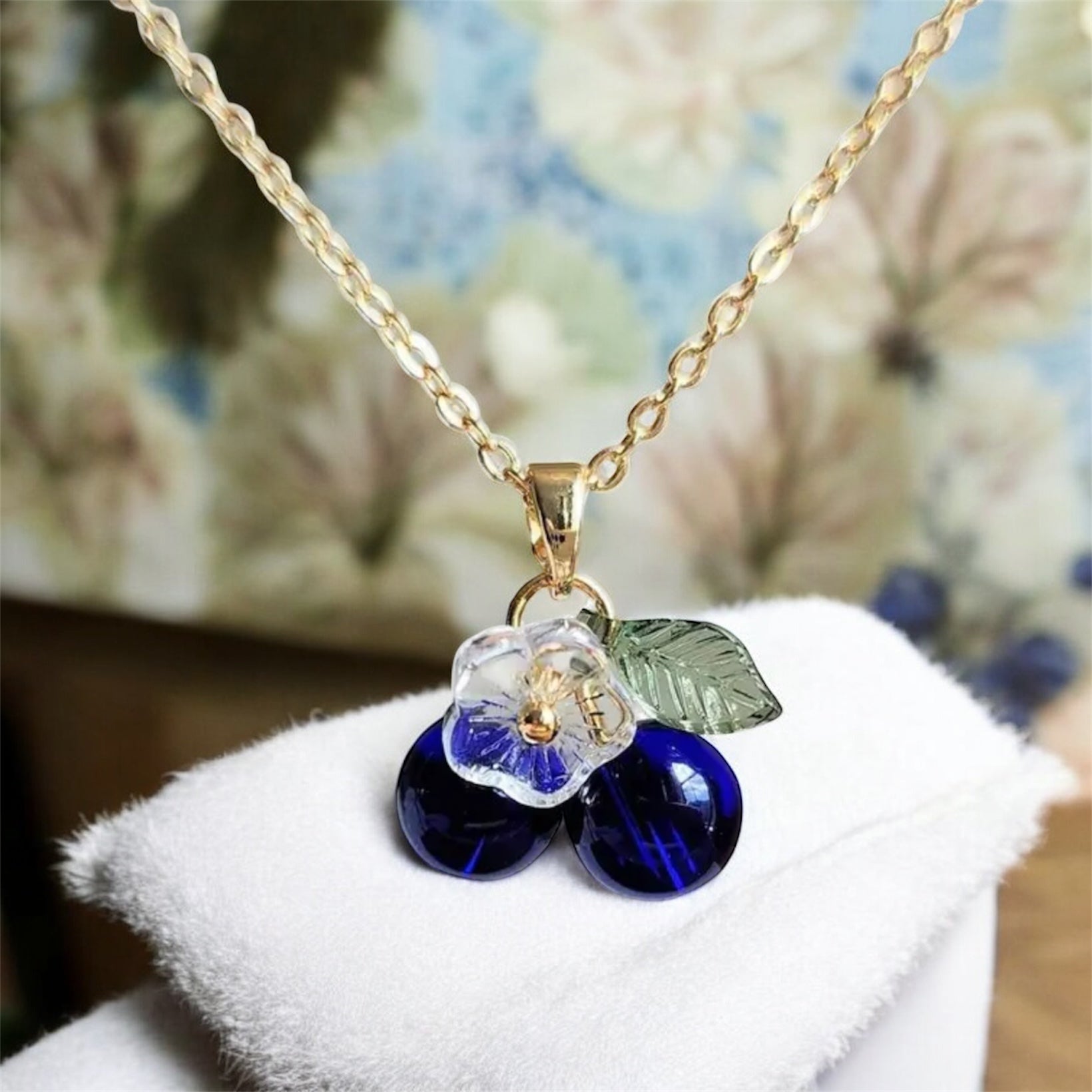 Blueberry Flower Necklace on a white surface.