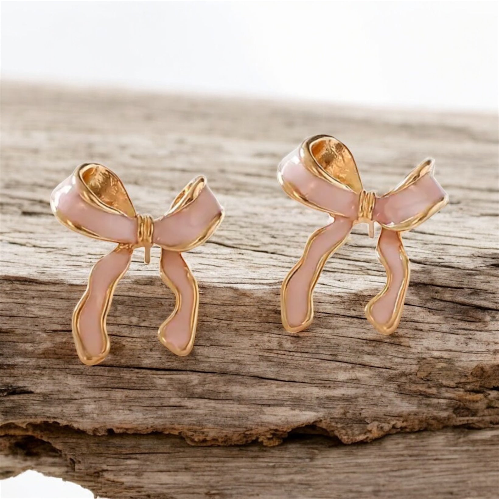 Pink Bow Earrings on wood background