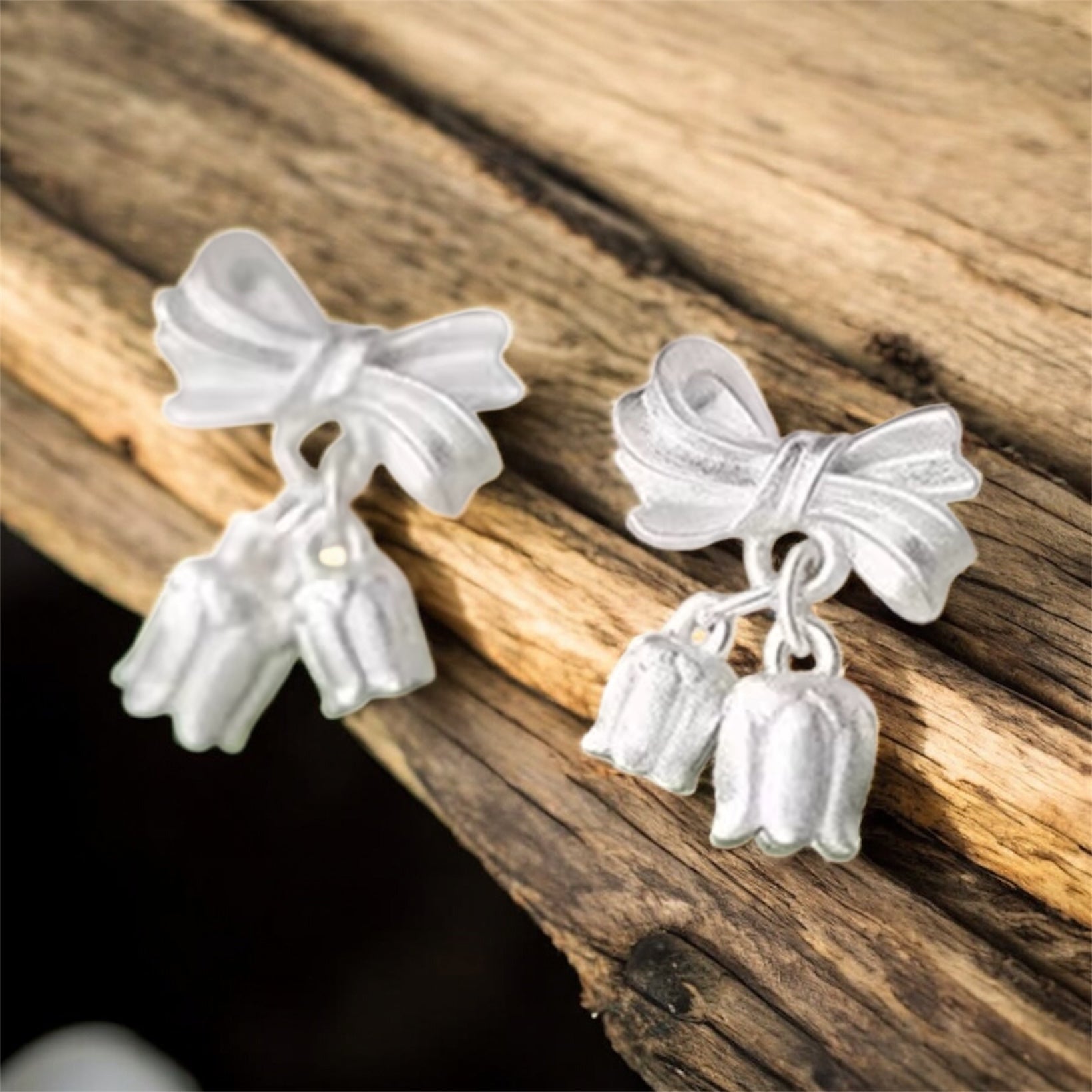 Bellflower Bow Earrings on a wooden surface