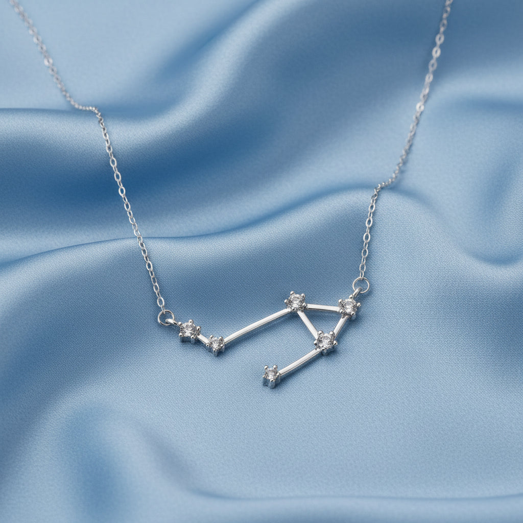 Silver Libra Zodiac Necklace on a light blue background