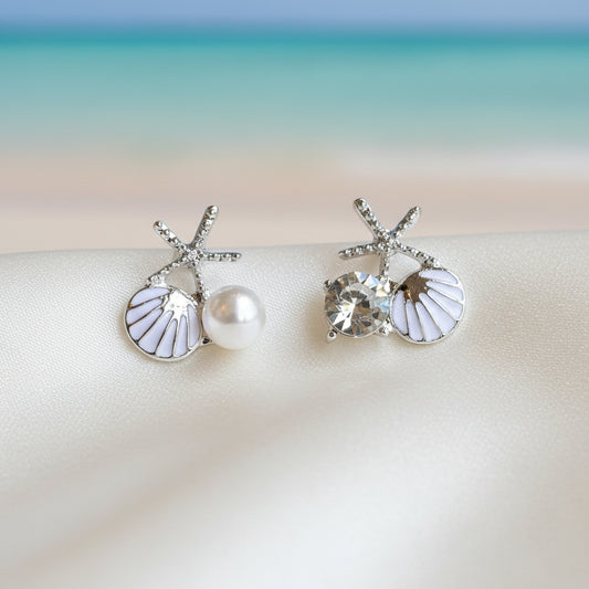 White Shell Pearl & Crystal Starfish Earrings on a white surface.