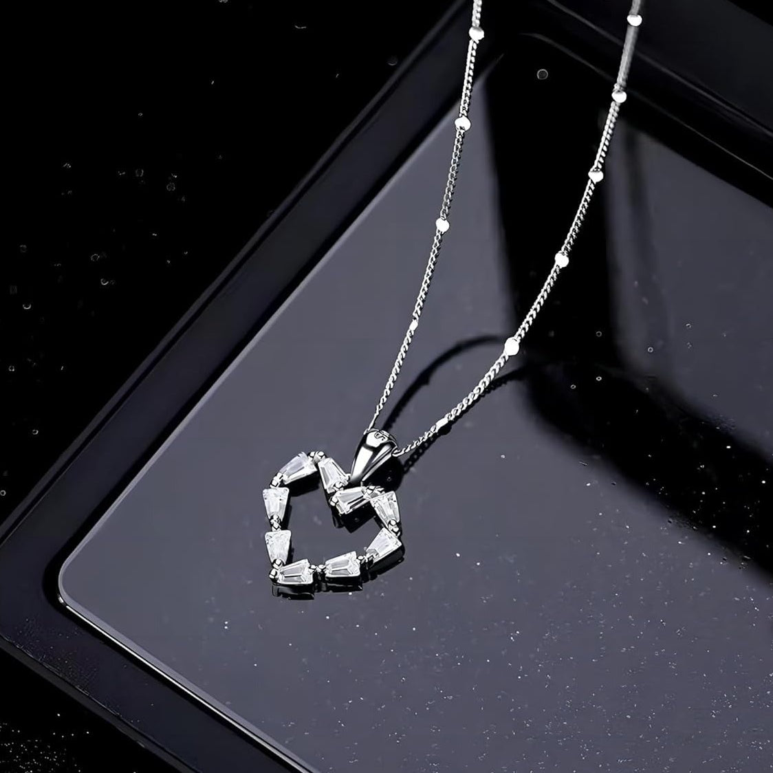 Silver Crystal Heart Necklace on a black background