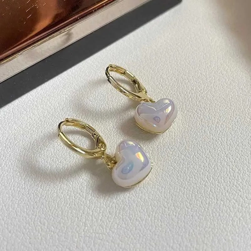 Iridescent Heart Drop Earrings with gold hooks on a light surface