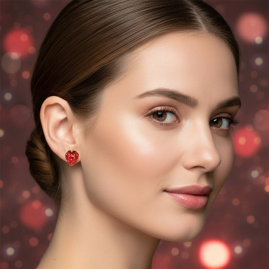 Close-up of a woman wearing Ruby Red Strawberry Earrings with a blurred bokeh background.