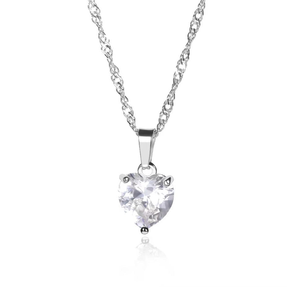 Heart-shaped diamond pendant on a chain against a white background