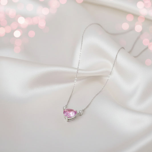 Pink Zirconia Heart Necklace on a white stand with a gray background