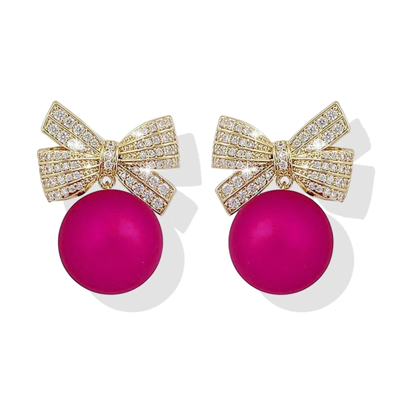 Pink ornament bow earrings on a white background