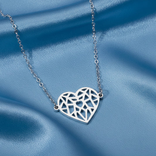 Silver Origami Heart Necklace on a blue satin background