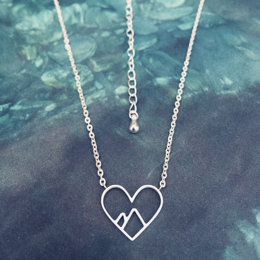 Silver stainless steel mountain heart necklace with a heart-shaped pendant and a chain.