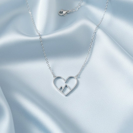 Silver stainless steel mountain heart necklace with a heart-shaped pendant and a chain.