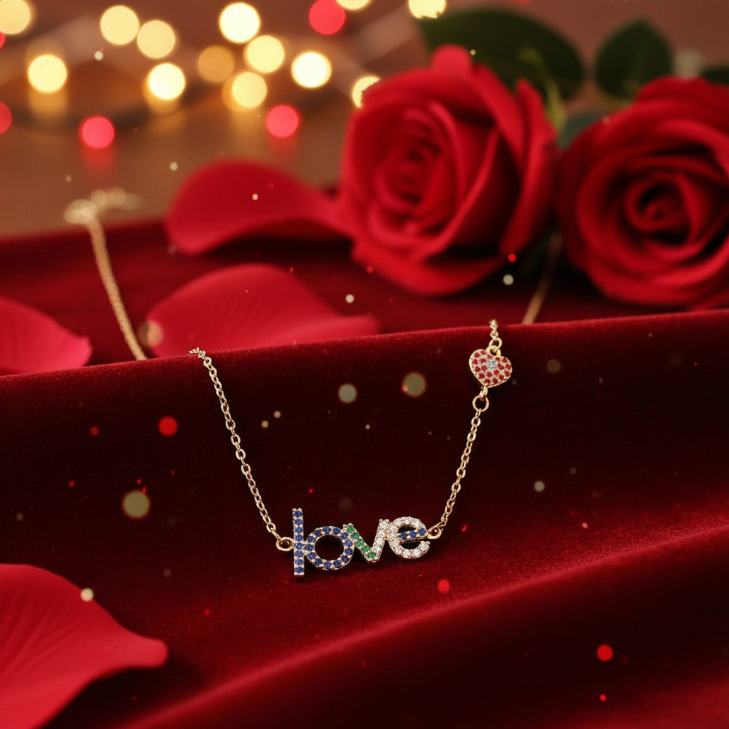 Love Heart Necklace with 'love' pendant on red fabric with blurred lights and roses in the background