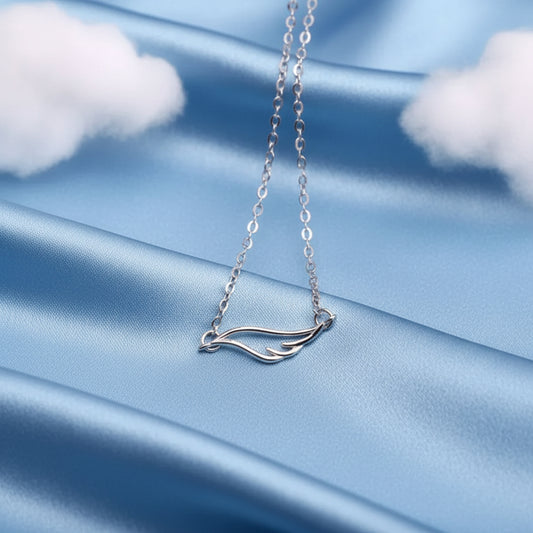 Angel Wing Necklace on a blue fabric background