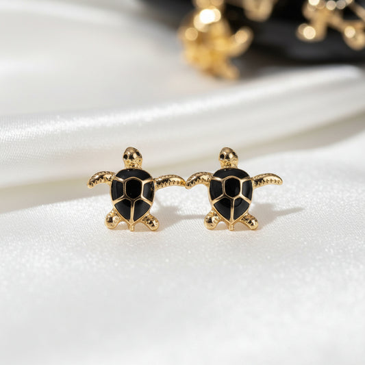 Black & Gold Sea Turtle Earrings on a white surface