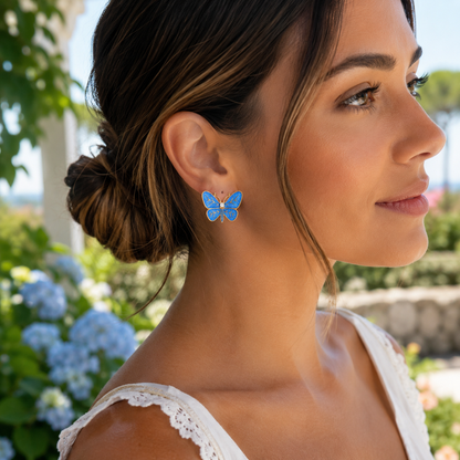 Woman wearing Blue Butterfly Statement Earrings with a garden background