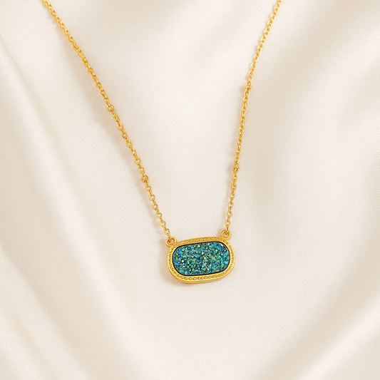 Blue Druzy Oval Pendant Gold Necklace with a turquoise pendant on a beige background