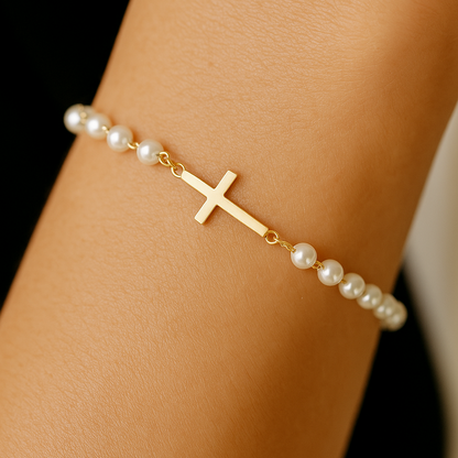 Gold Cross Pearl Bracelet/Anklet on a wrist against a black background