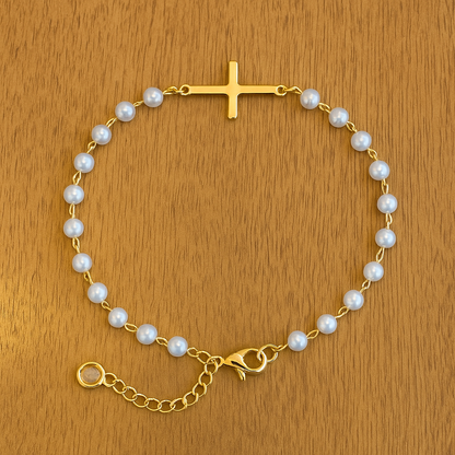 Gold Cross Pearl Bracelet/Anklet on a wooden surface
