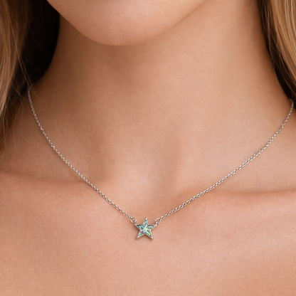 Iridescent Opal Star Necklace with a gemstone and silver chain on a person's neck