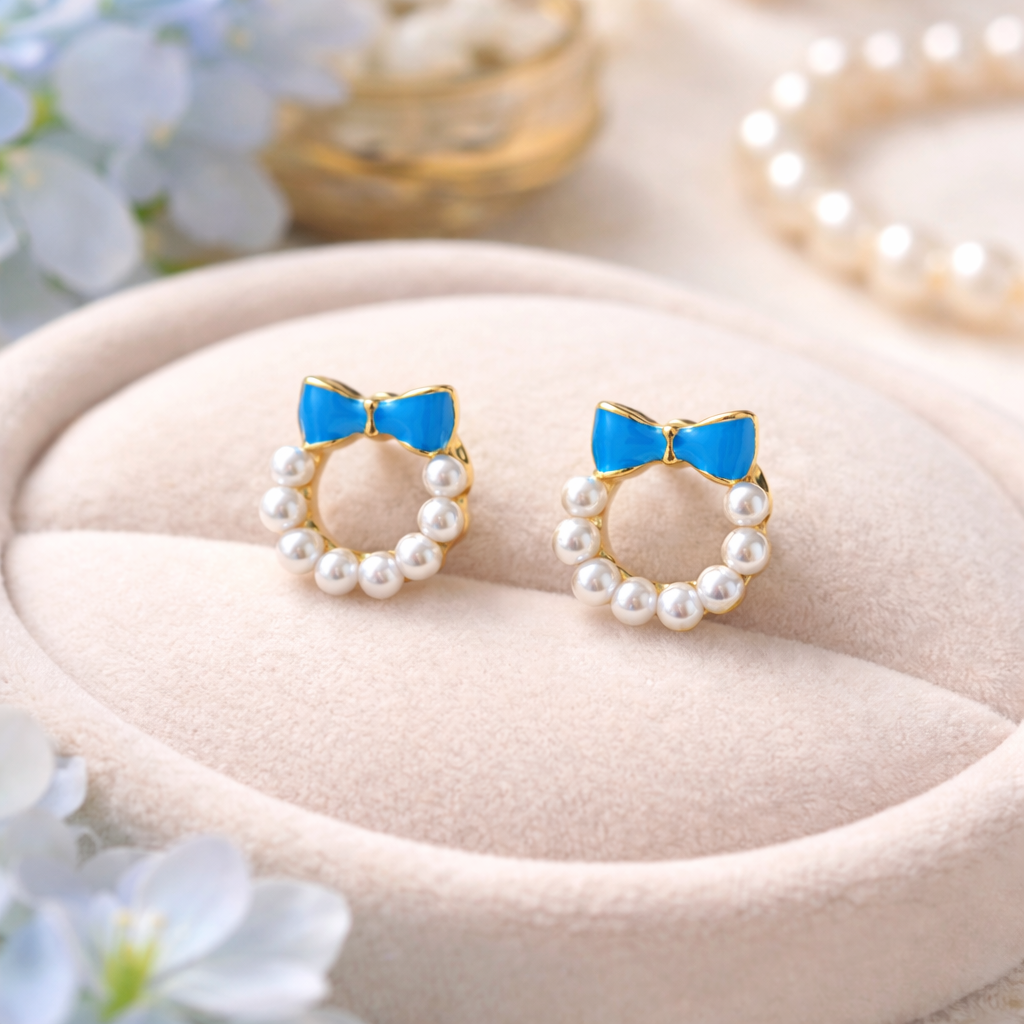 Blue Bow Pearl Wreath Earrings on a soft surface with flowers in the background