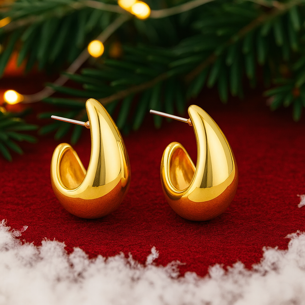 Gold Teardrop Hoop Earrings on a red fabric with Christmas decorations