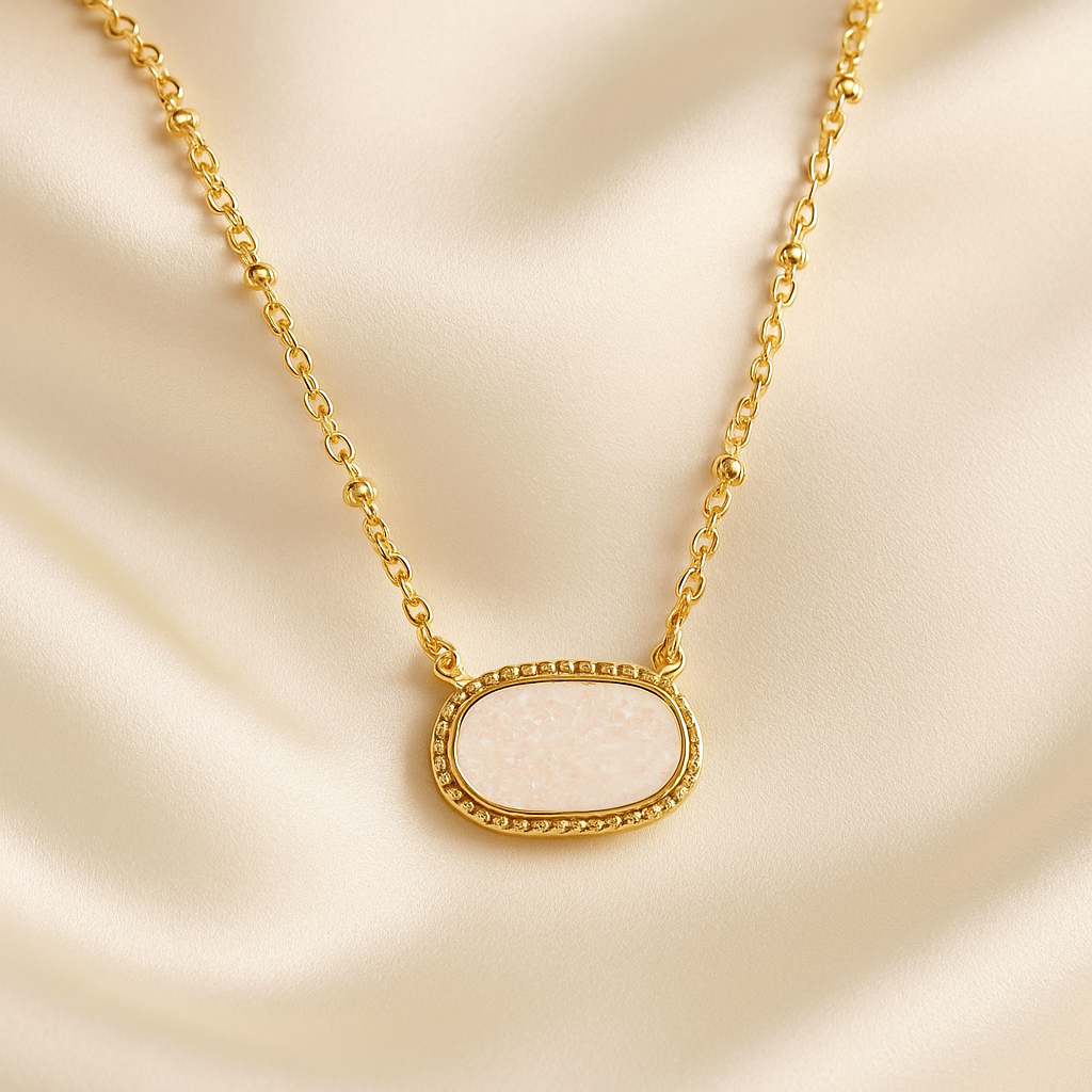 White Opal Druzy Glow Pendant Gold Necklaceon a beige fabric background