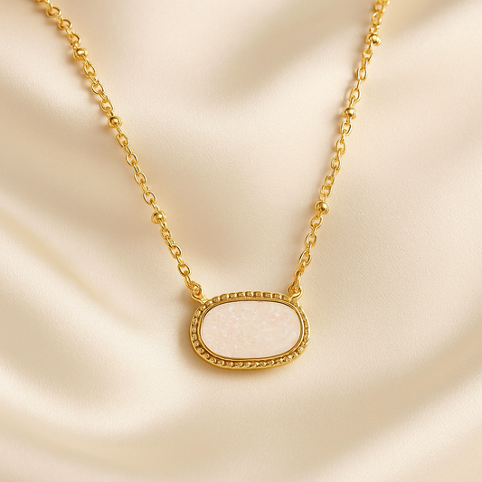 White Opal Druzy Glow Pendant Gold Necklaceon a beige fabric background