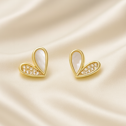 White Heart Rhinestone Earrings with embedded stones on a satin background