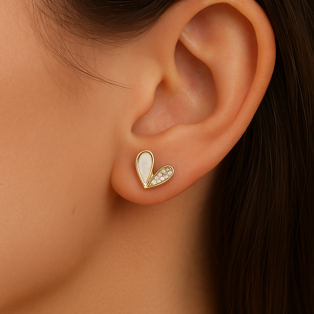 White Heart Rhinestone Earrings worn on an ear with a blurred background