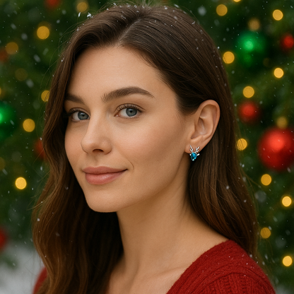 Woman wearing Crystal Blue Reindeer Earrings with a festive background of Christmas lights and decorations