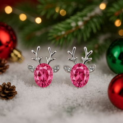 Reindeer antler earrings with pink gemstones on a snowy background with Christmas decorations.