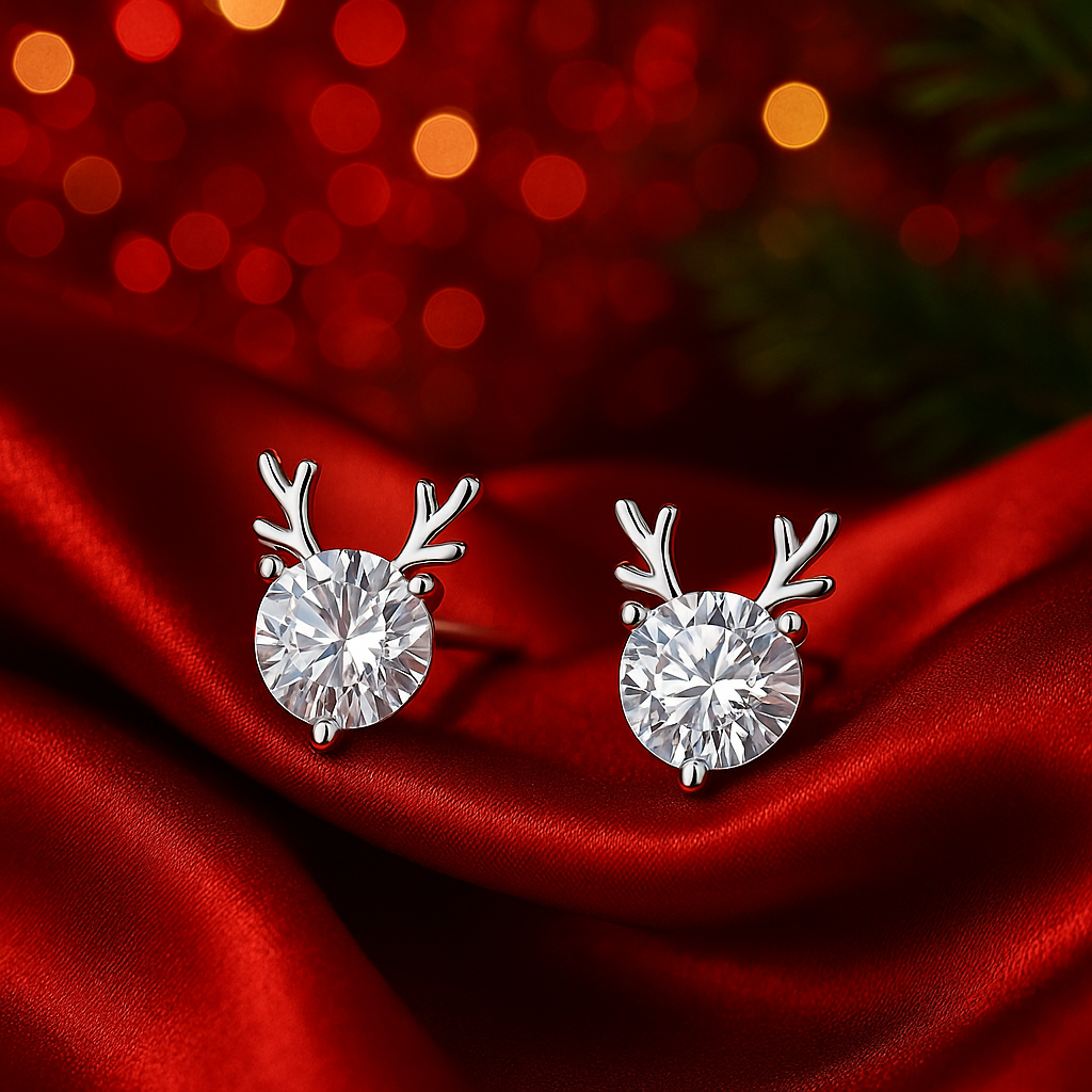 Crystal Silver Reindeer Earrings on a red fabric background with blurred lights