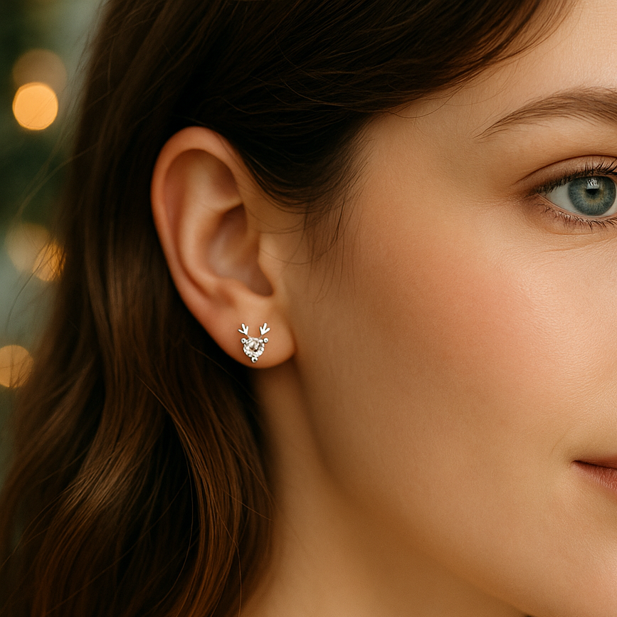 Close-up of a woman wearing Crystal Silver Reindeer Earrings with a blurred background