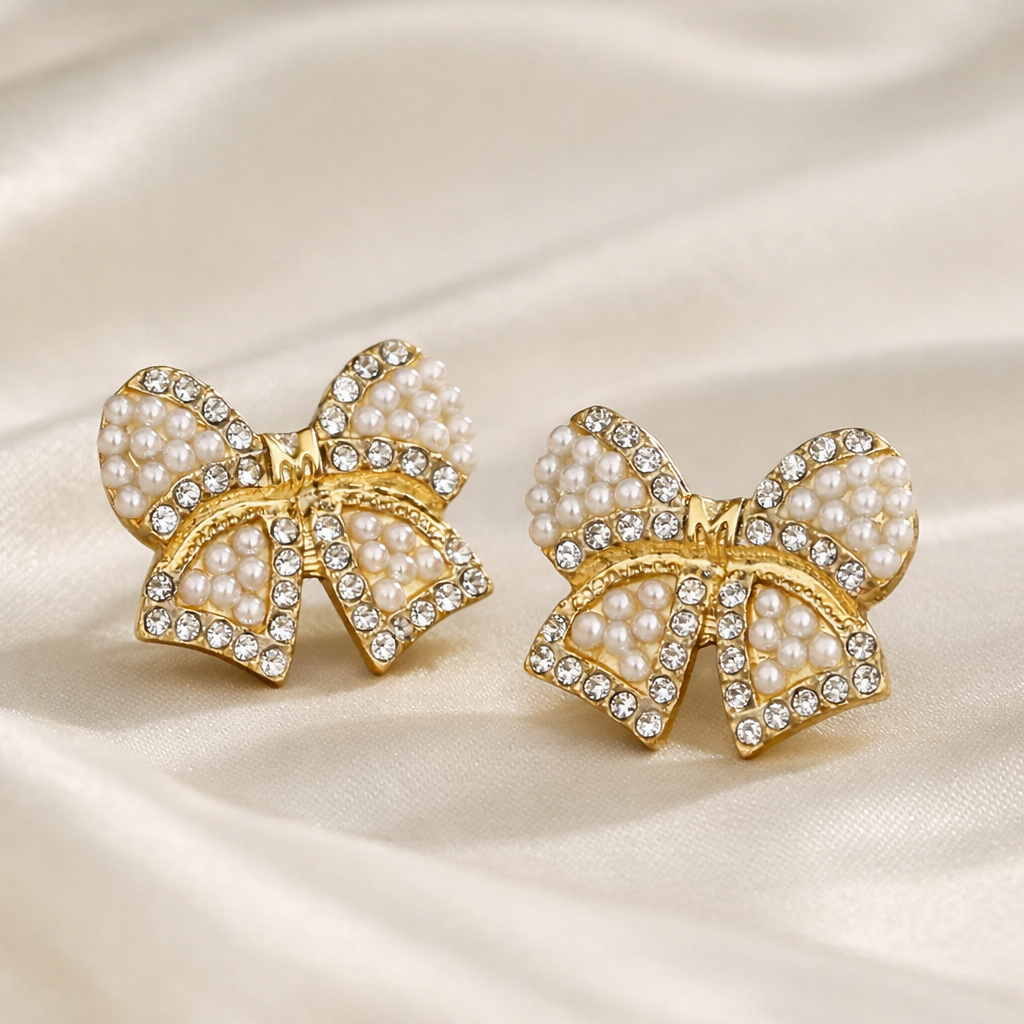 Classic Pearl Bow & CZ Earrings with pearl details on a satin background