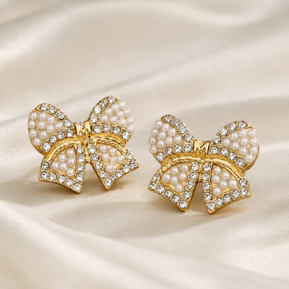 Classic Pearl Bow & CZ Earrings with pearl details on a satin background