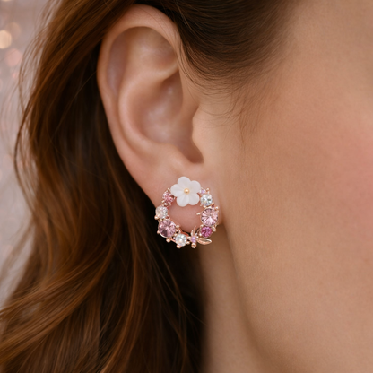 Close-up of an ear wearing a Pink & White Flower Wreath Earring