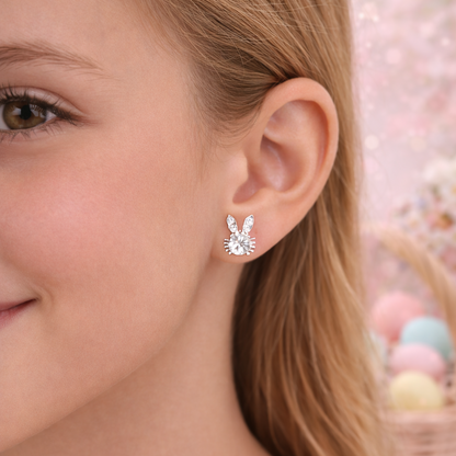 Close-up of a person wearing Sweet Bunny Sparkle Earrings with a blurred background