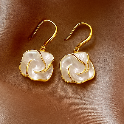 Golden Edge Pearl Drop Earrings on a brown satin background