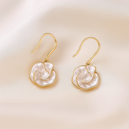 Golden Edge Pearl Drop Earrings on a beige background