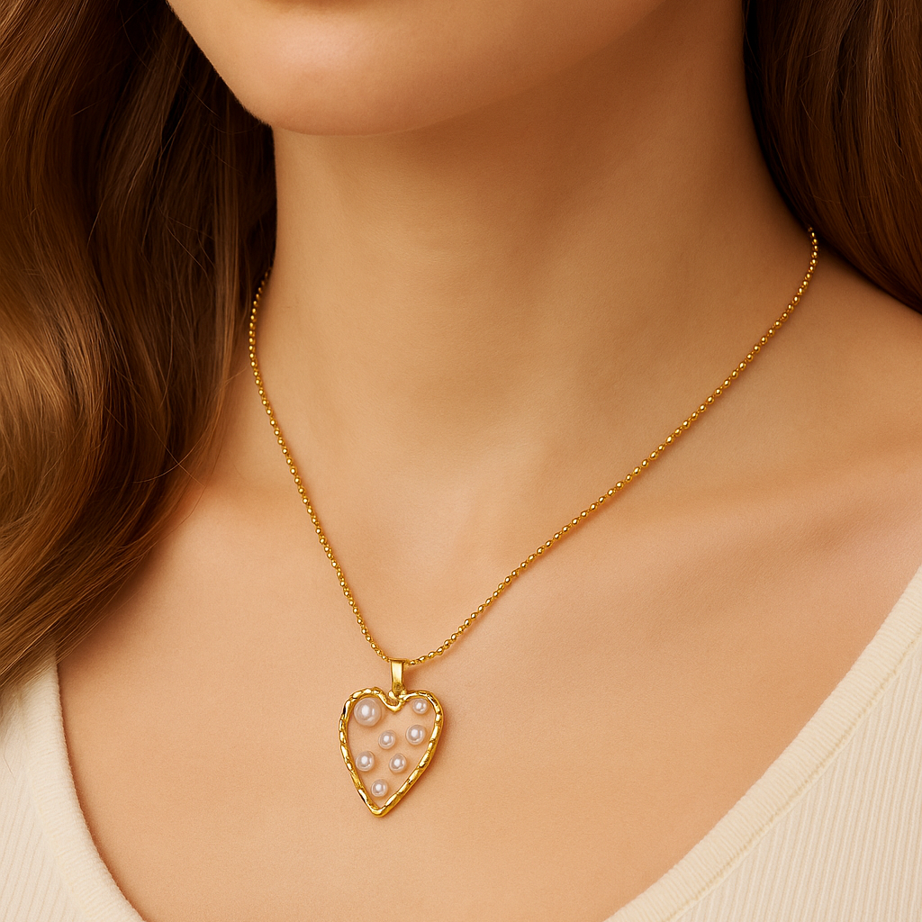 Close-up of a person wearing a Golden Heart Pearl Necklace with a heart-shaped pendant.