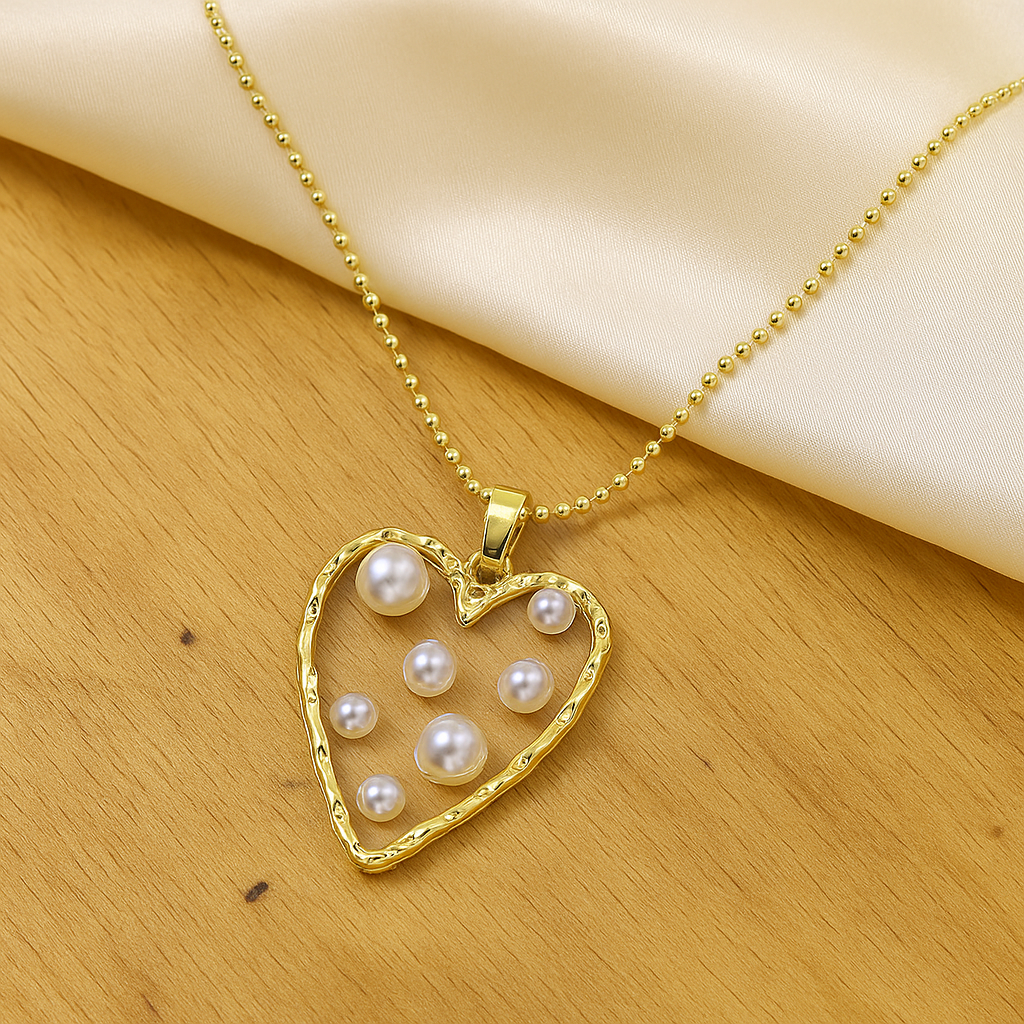 Golden Heart Pearl Necklace on a wooden surface