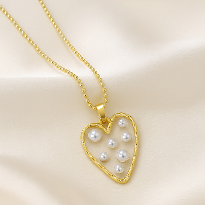 Golden Heart Pearl Necklace with pearls on a beige background