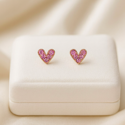 Petite Pink Zircon Heart Earrings on a beige fabric background