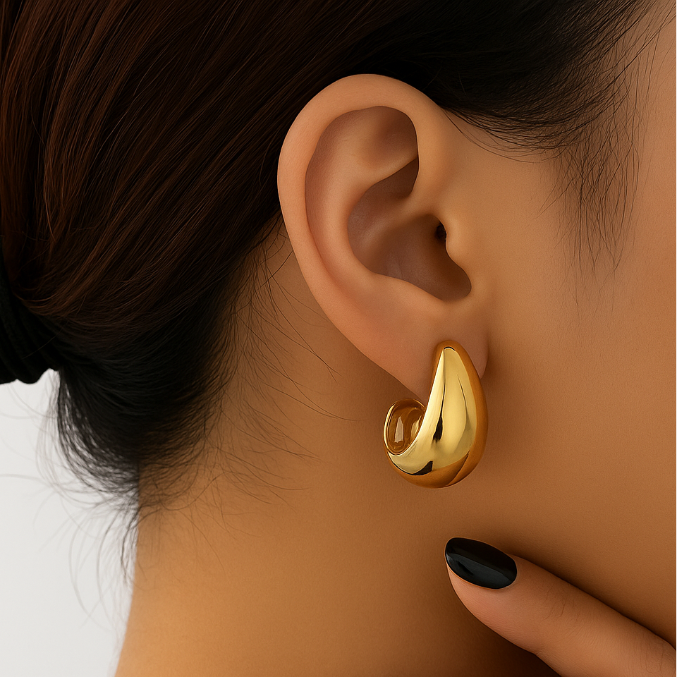 Gold Teardrop Hoop Earrings worn by a person with a neutral background