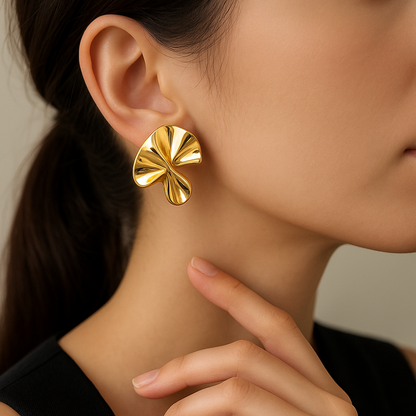 Gold Sculpted Petal Earrings worn by a person with a neutral background