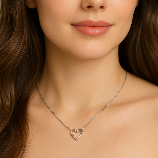 Woman wearing a Sterling Silver Open Heart Necklace against a neutral background