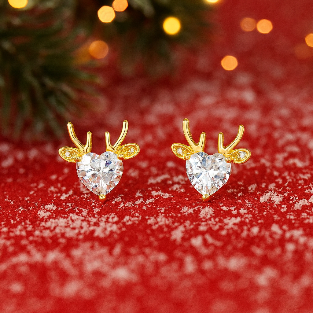 Gold Reindeer Zircon Heart Earrings with heart-shaped gemstones on a red background with snow effect