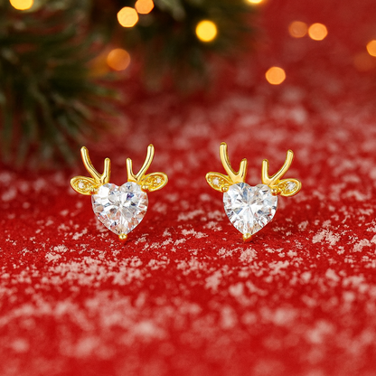 Gold Reindeer Zircon Heart Earrings with heart-shaped gemstones on a red background with snow effect