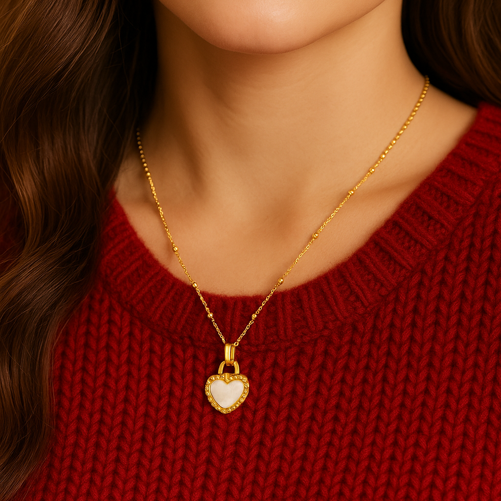 Close-up of a person wearing a Black/White Reversible Gold Heart Necklace, against a neutral background.
